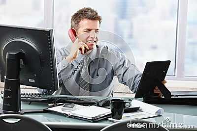 Happy businessman on phone calling family Stock Photo
