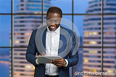 Happy businessman on skyscraper background. Stock Photo