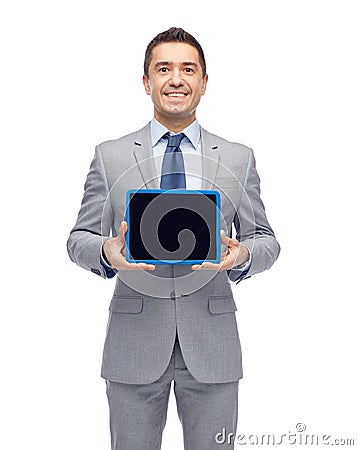 Happy businessman in suit showing tablet pc screen Stock Photo