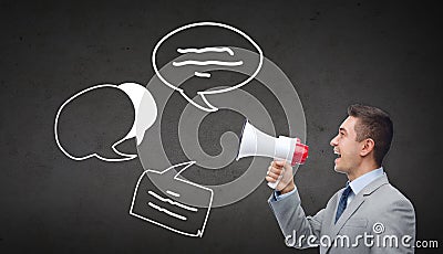 Happy businessman in suit speaking to megaphone Stock Photo