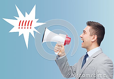 Happy businessman in suit speaking to megaphone Stock Photo