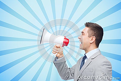 Happy businessman in suit speaking to megaphone Stock Photo