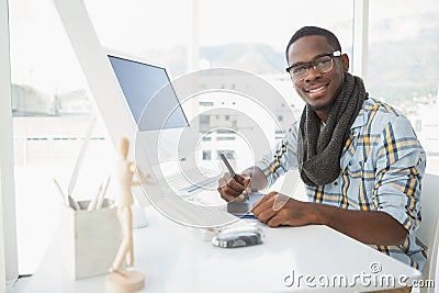 Happy businessman using digitizer at desk Stock Photo