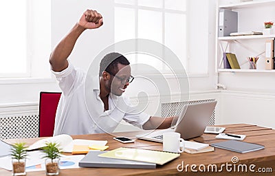 Happy businessman win. Winner, black man in office Stock Photo