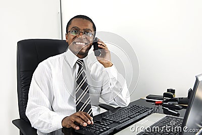 Happy businessman working at desk smiling Stock Photo