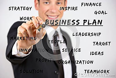 Happy businessman writing business keywords with marker Stock Photo