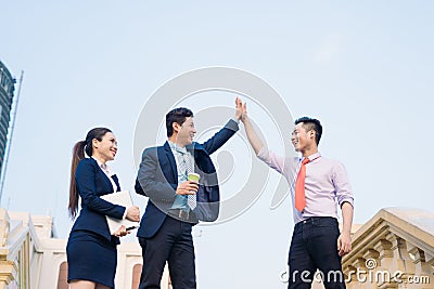Happy businessmen and businesswoman celebrate success in project task achievement Stock Photo
