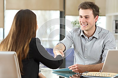 Happy businesspeople handshaking at office Stock Photo