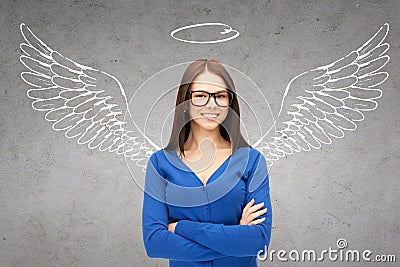 Happy businesswoman with angel wings and nimbus Stock Photo