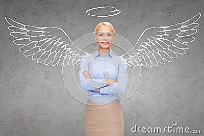 Happy businesswoman with angel wings and nimbus Stock Photo