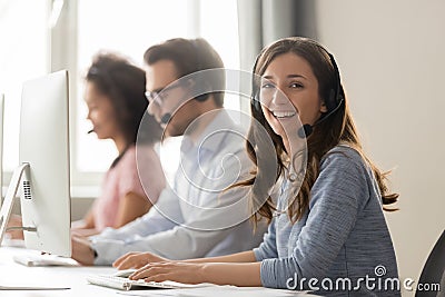 Happy businesswoman call center agent looking at camera at workplace Stock Photo