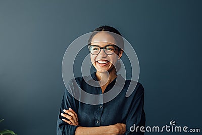 Happy businesswoman with crossed arms Stock Photo