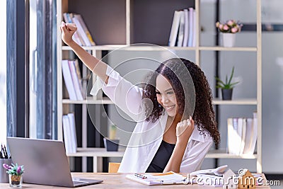 Happy businesswoman laughing with joy at the good news about work at the workplace, gladly looking at laptop screen, feeling Stock Photo