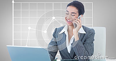 Happy businesswoman using laptop and mobile phone against graph Stock Photo