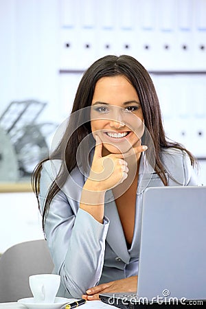 Happy businesswoman working with laptop Stock Photo