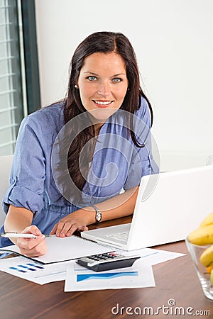 Happy businesswoman working office writing calculating finance Stock Photo