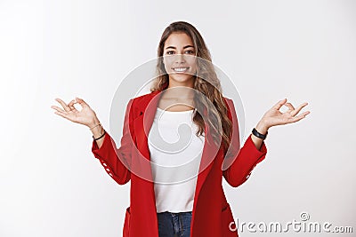 Happy calm stress-free modern 25s businesswoman control feelings hands sideways showing mudra zen gesture smiling Stock Photo