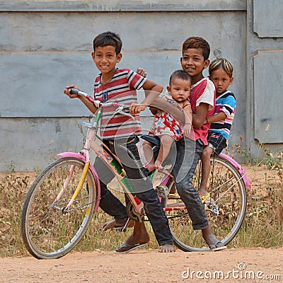 Children riding a pushbike together Editorial Stock Photo