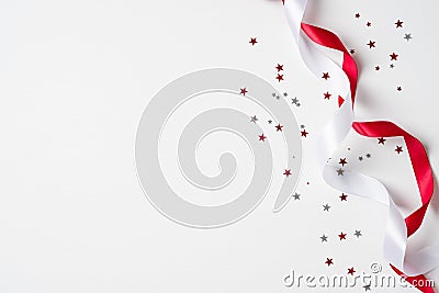 Happy Canada Day banner mockup. Canada flag colors confetti and ribbons on white background. Canadian Independence Day celebration Stock Photo