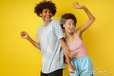 Happy and carefree boyfriend and girlfriend dance together Stock Photo