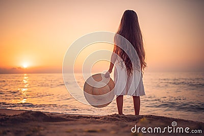 Happy Carefree Girl on the Beach at Sea Sunrise Stock Photo