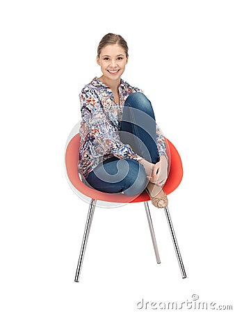 Happy and carefree teenage girl in chair Stock Photo