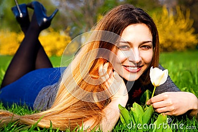 Happy carefree woman with flower and grass Stock Photo