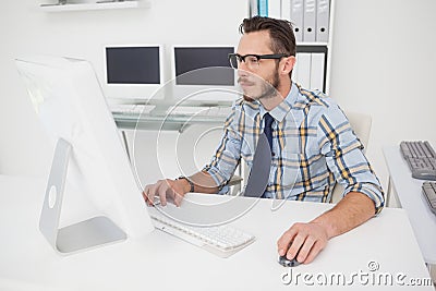 Happy casual businessman working at his desk Stock Photo