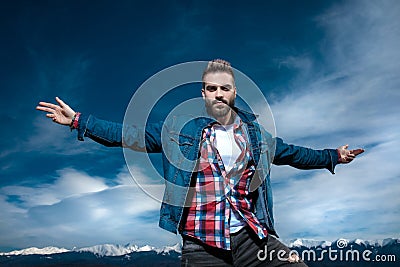 Happy casual man dreaming of big outdoor adventures and celebrates Stock Photo