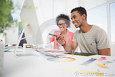 Happy casual photo editors using graphics tablet Stock Photo