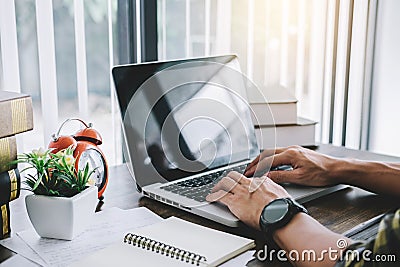 Happy casual young asian man working in home or small office wit Stock Photo