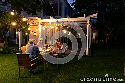 Happy Caucasian family eating together at table Stock Photo