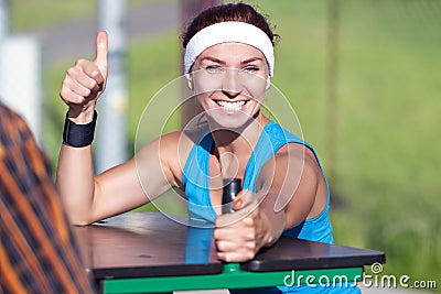 Happy Caucasian Ginger Female in Sport Outfit with Armrestling Stock Photo