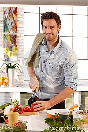 Happy caucasian man cooking in kitchen at home Stock Photo