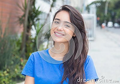 Happy caucasian woman with blue shit in city Stock Photo