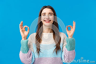 Happy charismatic gorgeous woman in winter sweater, say yes, alright, showing okay gestures, rate excellent movie Stock Photo