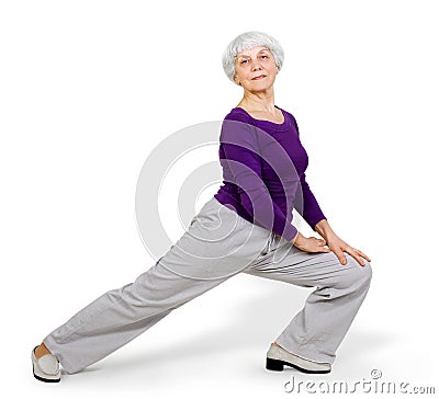 Happy charming beautiful elderly woman doing exercises while working out playing sports Stock Photo