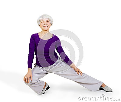 Happy charming beautiful elderly woman doing exercises while working out playing sports Stock Photo