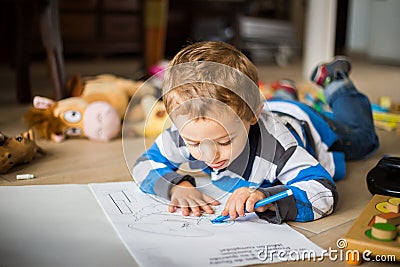 Happy cheerful child drawing at home. Creativity concept. Stock Photo