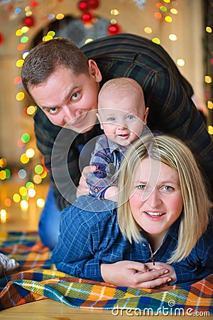 Cheerful family on the background of bright festive decorations, in anticipation of the holiday Stock Photo