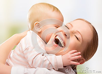 Happy cheerful family. Mother and baby kissing Stock Photo