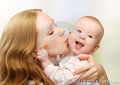 Happy cheerful family. Mother and baby kissing Stock Photo