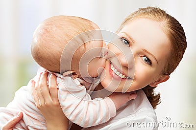Happy cheerful family. Mother and baby kissing Stock Photo