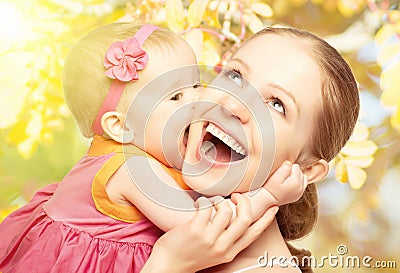 Happy cheerful family. Mother and baby kissing in nature outdoor Stock Photo