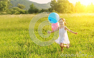 Happy cheerful girl playing and having fun with balloons in the summer Stock Photo