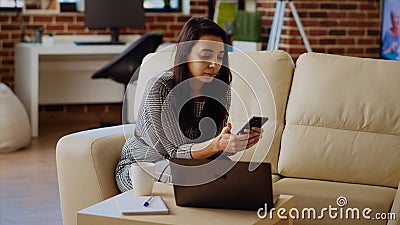 Entertained woman scrolling on social media feed Stock Photo