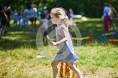 Happy cheerful preschool girl walking in park Stock Photo