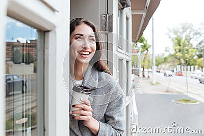 Happy cheerful smiling girl holding take away coffee Stock Photo