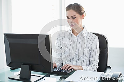 Happy chic businesswoman working on her computer Stock Photo