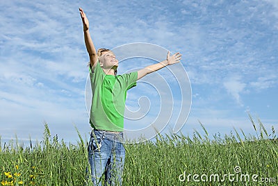 Happy child arms raised in prayer Stock Photo